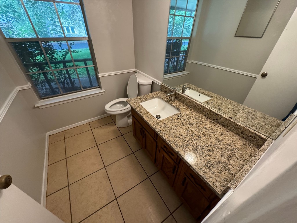 4204 Everest Lane Austin, TX 78727 - Photo 3 of 13 a bathroom with a granite countertop sink and a toilet
