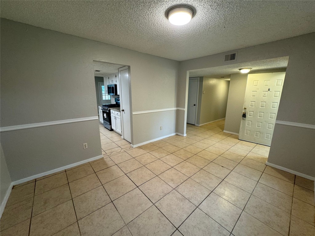 4204 Everest Lane Austin, TX 78727 - Photo 7 of 13 an empty room with wooden floor and mirror