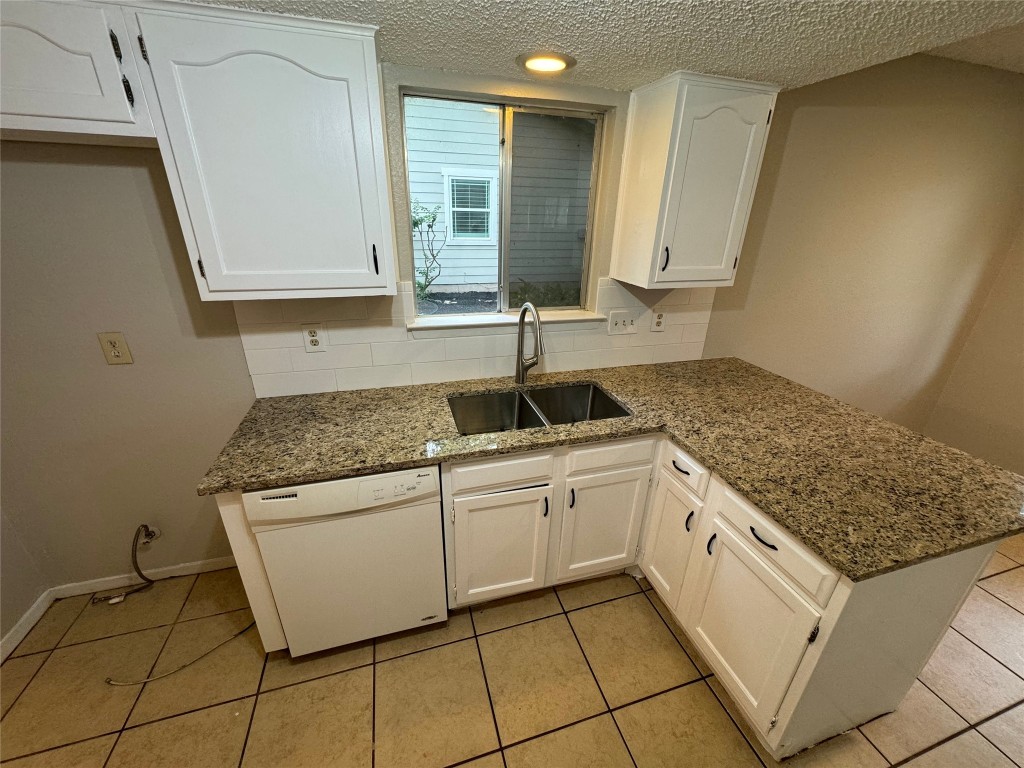 4204 Everest Lane Austin, TX 78727 - Photo 10 of 13 a kitchen with stainless steel appliances granite countertop a sink stove and cabinets