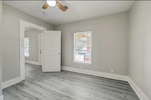 wooden floor in an empty room with a window
