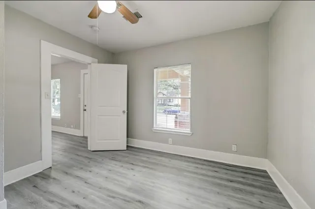 wooden floor in an empty room with a window