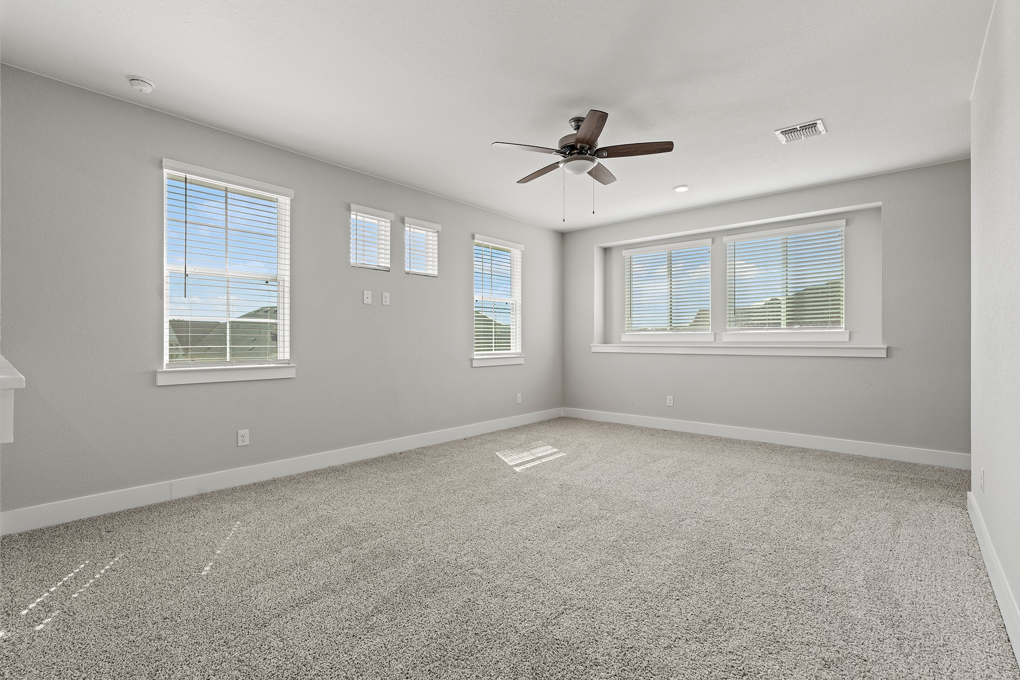 2112 Tobiano Trace Georgetown, TX 78633 - Photo 31 of 40 Empty room with light carpet and ceiling fan