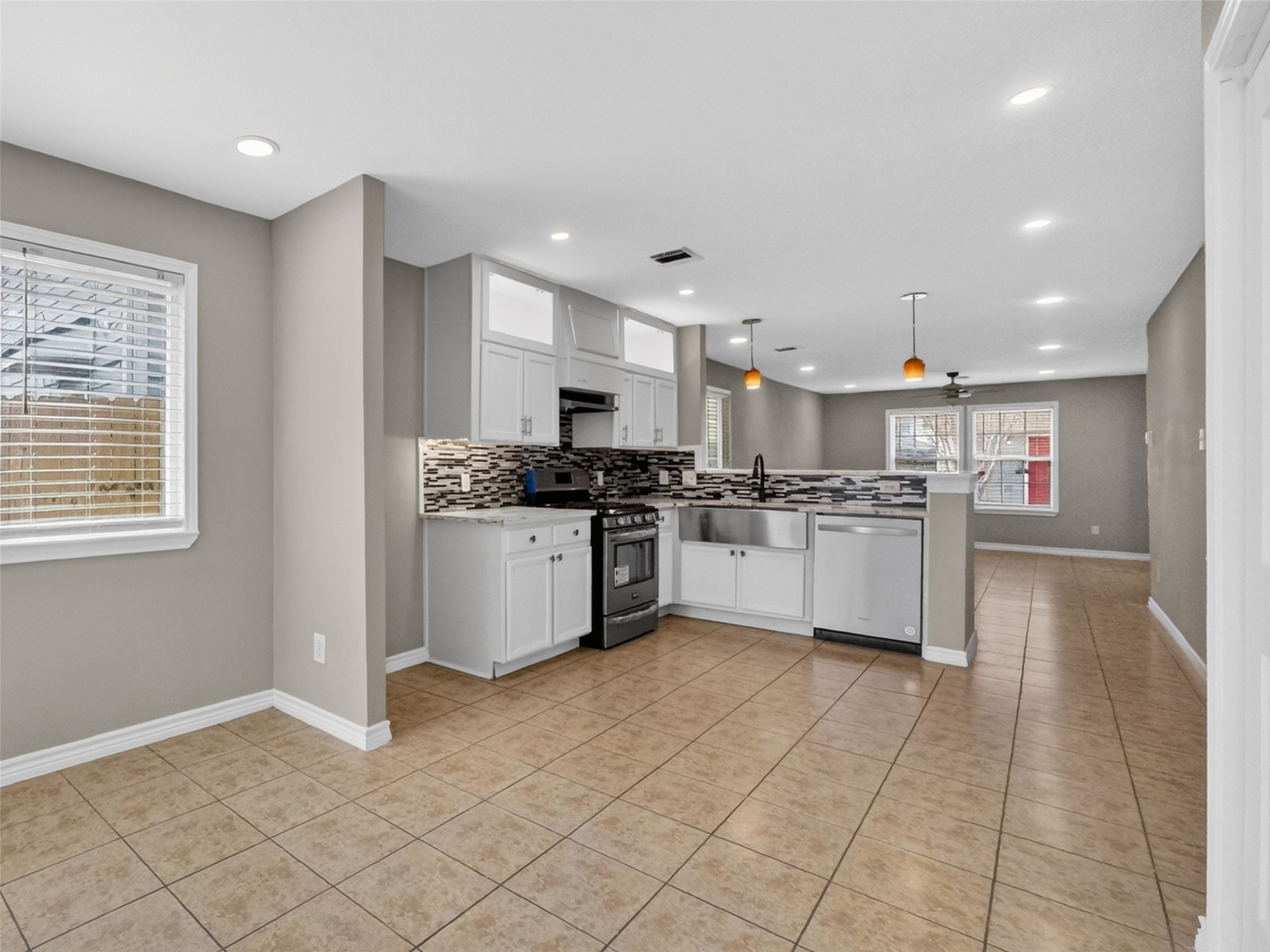 6231 Lone Prairie Way Katy, TX 77449 - Photo 10 of 27 Dinner’s up. Serve meals with style in the open dining area that keeps the conversation going from kitchen to couch.