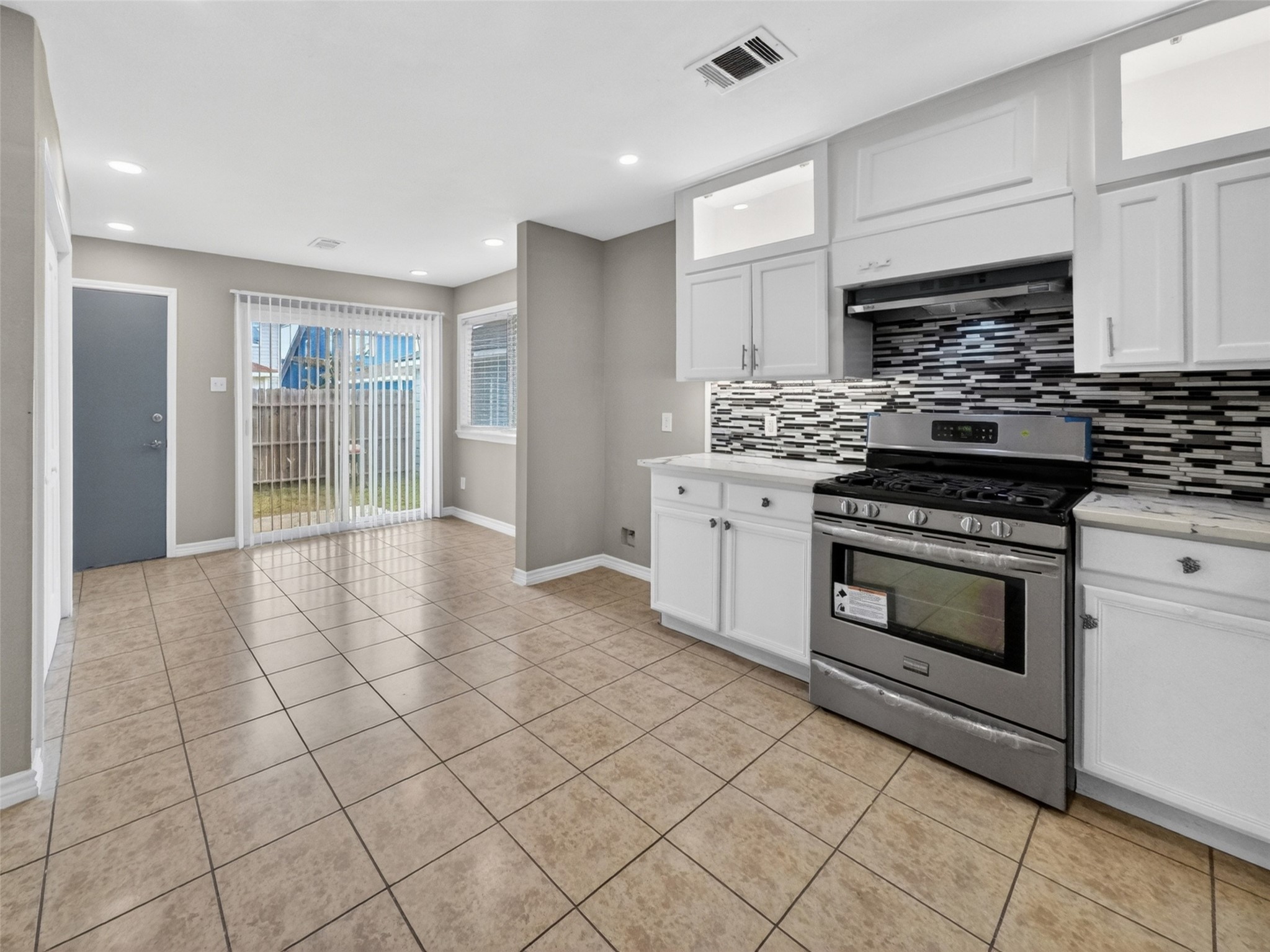6231 Lone Prairie Way Katy, TX 77449 - Photo 13 of 27 Whether you’re baking cookies or shaking cocktails, this kitchen’s ready with quartz counters, a sleek backsplash, and bar seating for your taste-testers.