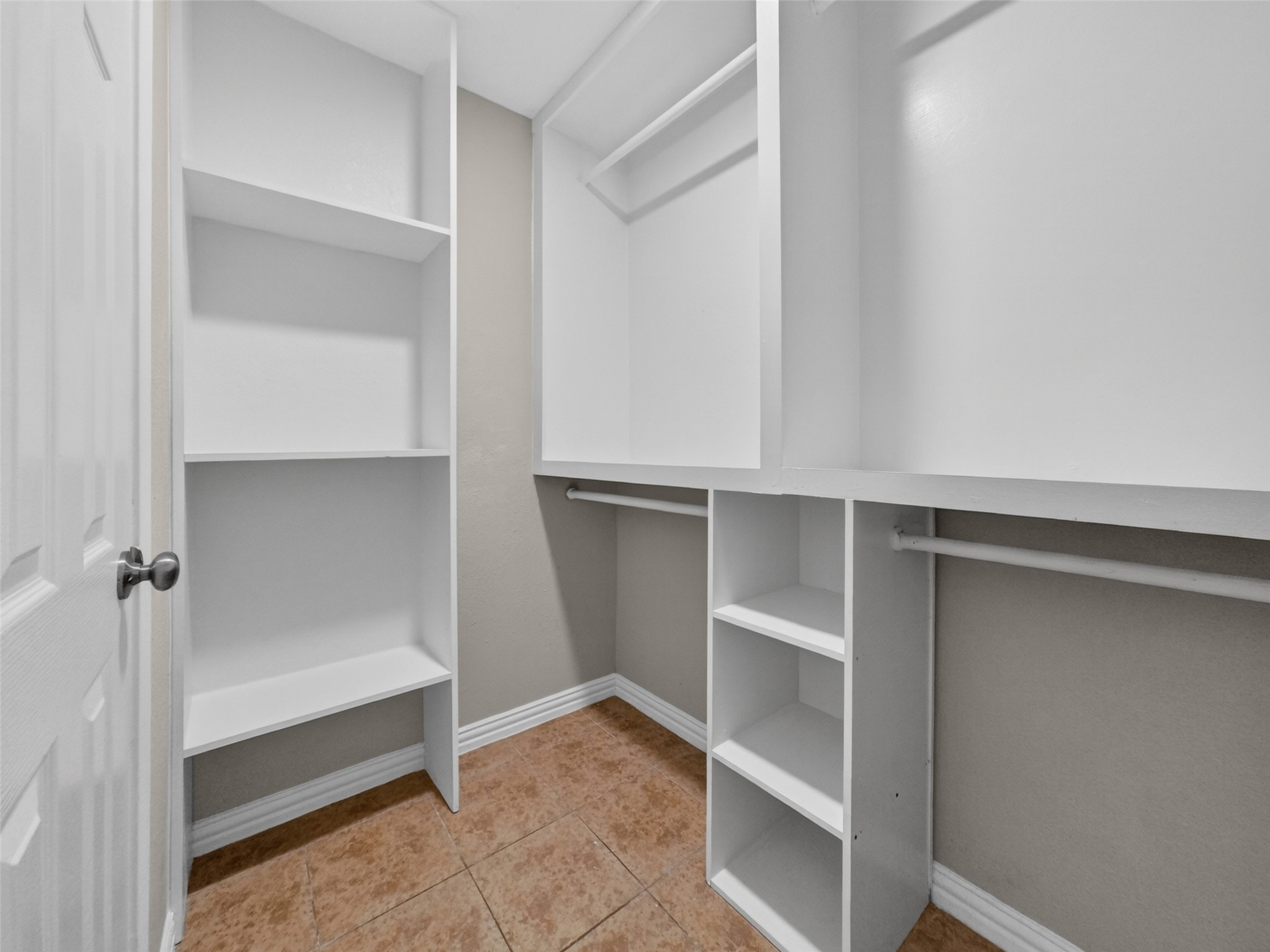 6231 Lone Prairie Way Katy, TX 77449 - Photo 19 of 27 Everything has a place in this walk-in closet—organized, tidy, and ready for your favorite outfits.