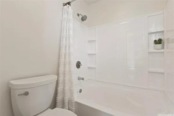 a bathroom with a toilet and shower