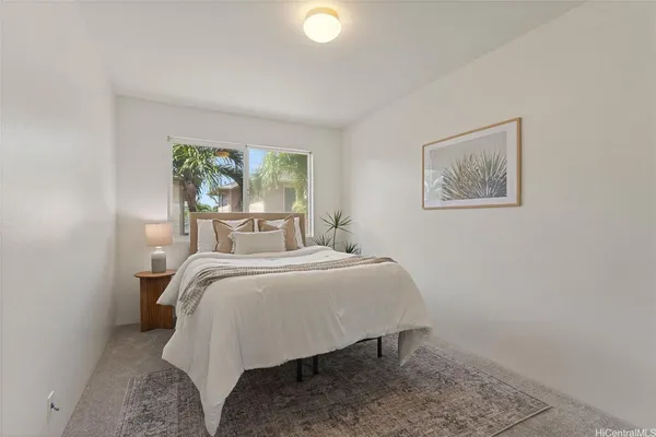 a bed sitting in a bedroom next to a window