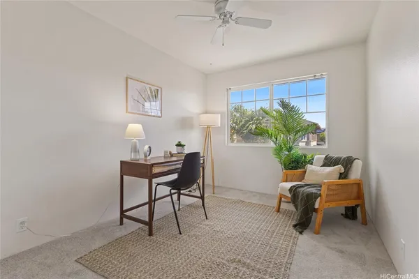 a living room with furniture and a potted plant