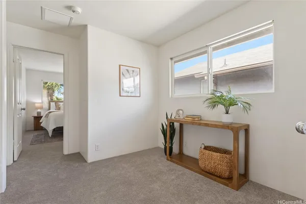 a living room with furniture and a potted plant