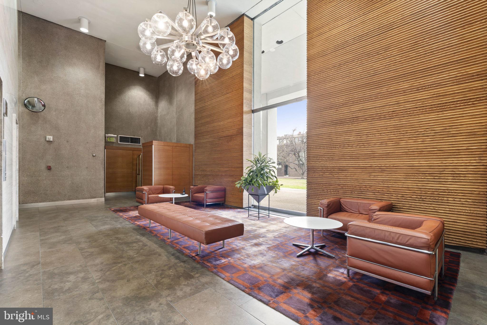 210 Locust Street, Unit 21E Philadelphia, PA 19106 - Photo 11 of 36 a living room with furniture and a chandelier