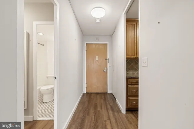 a view of an empty room with wooden floor