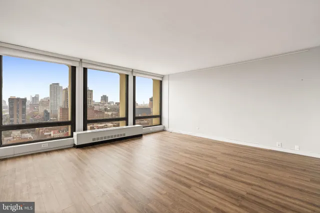 a living room with furniture and large windows