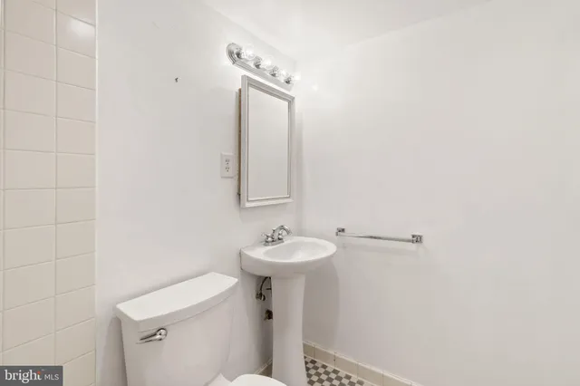 a view of a sink and dishwasher with wooden floor
