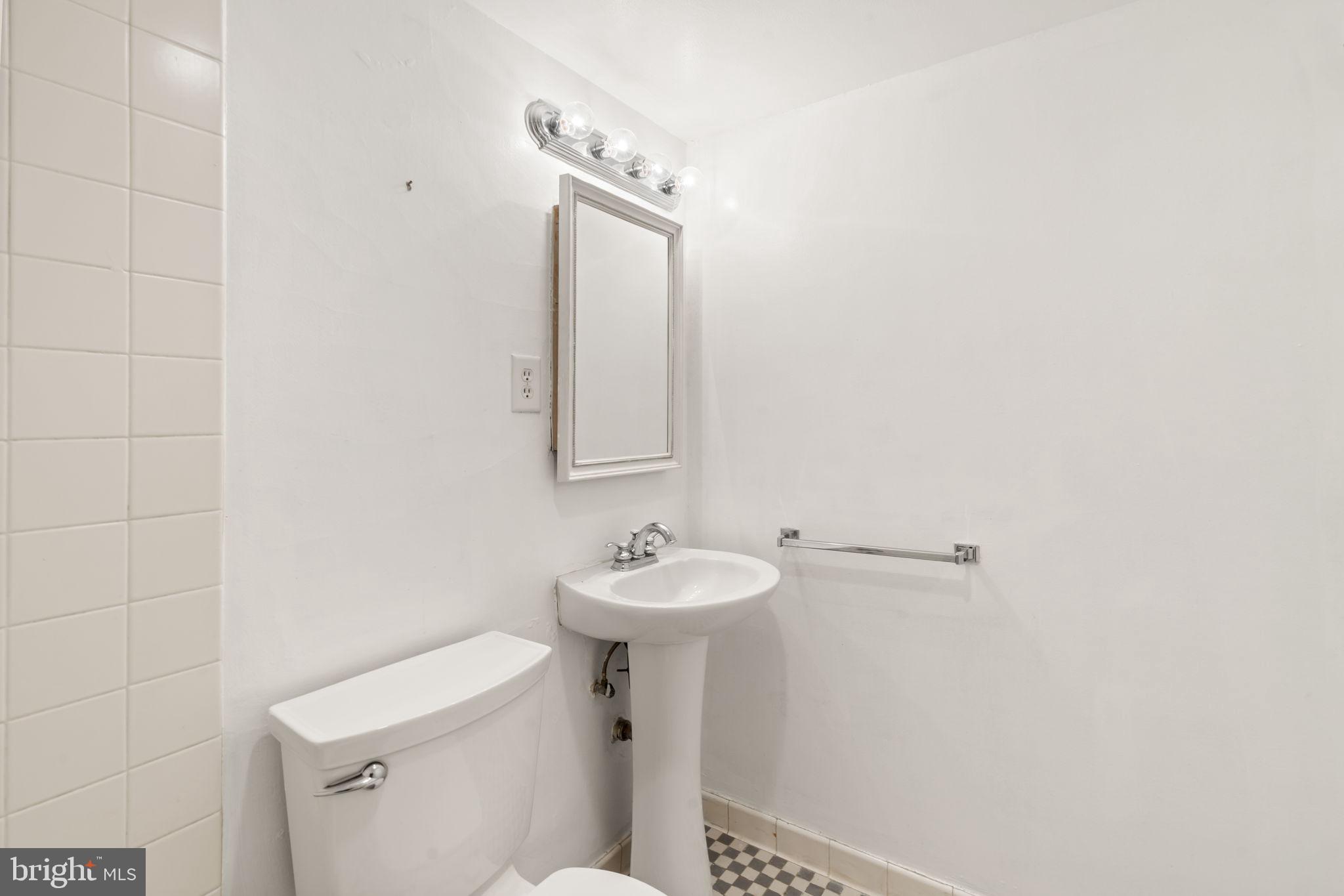 210 Locust Street, Unit 21E Philadelphia, PA 19106 - Photo 26 of 36 a bathroom with a sink toilet and a mirror