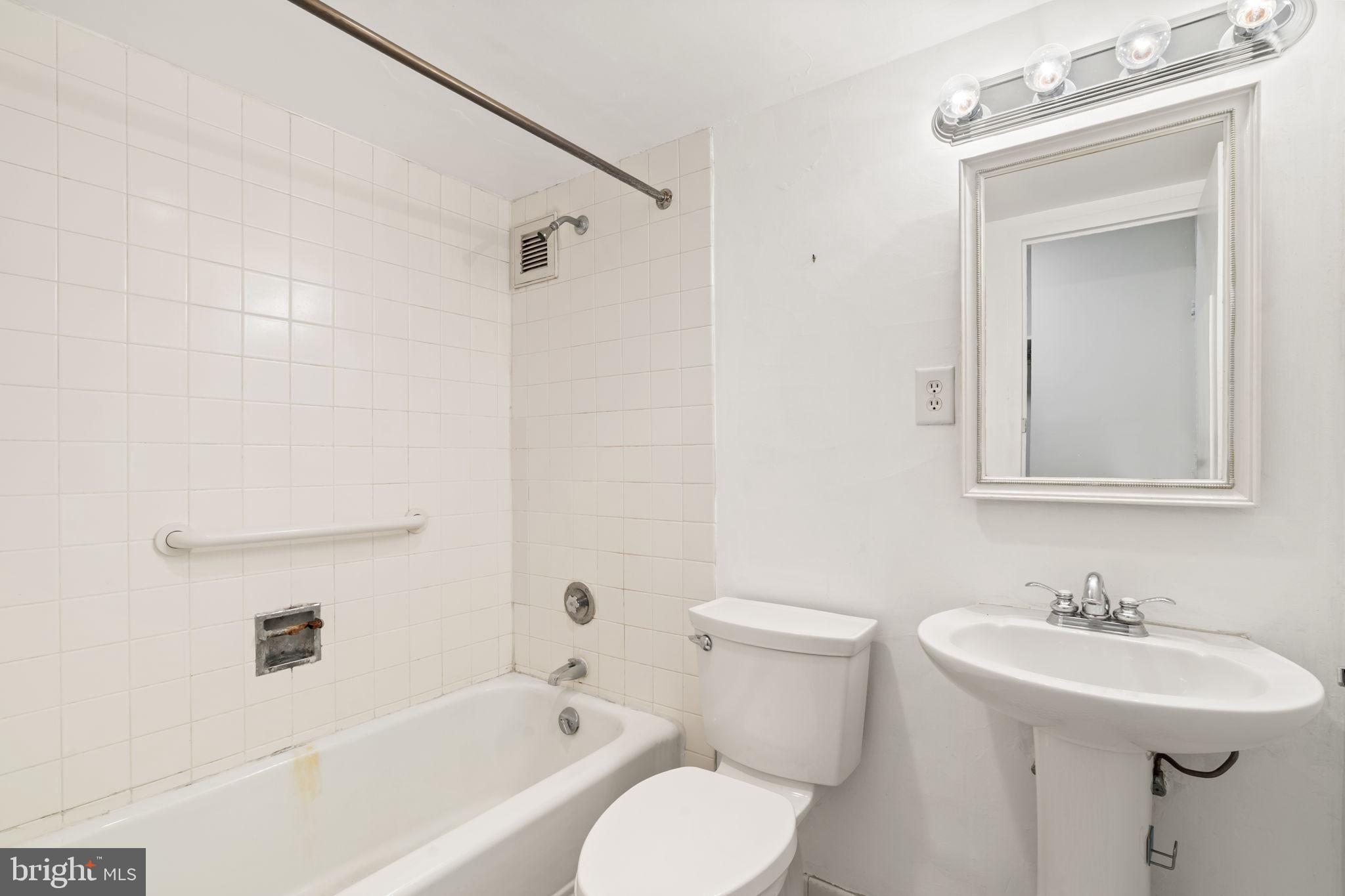 210 Locust Street, Unit 21E Philadelphia, PA 19106 - Photo 27 of 36 a bathroom with a sink toilet and shower
