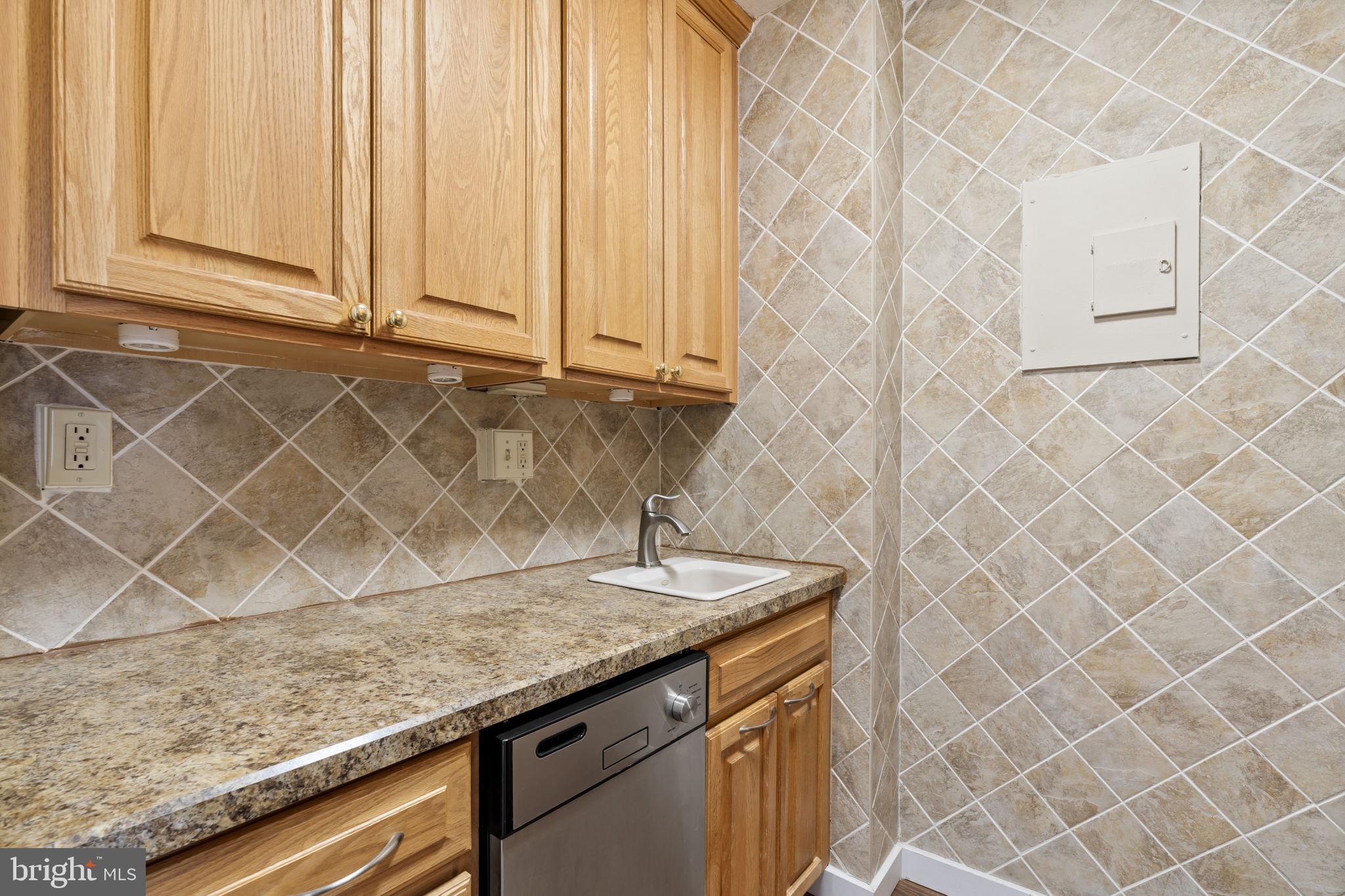 210 Locust Street, Unit 21E Philadelphia, PA 19106 - Photo 30 of 36 a view of a sink and dishwasher with wooden floor