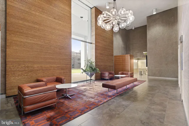 a living room with furniture and a chandelier