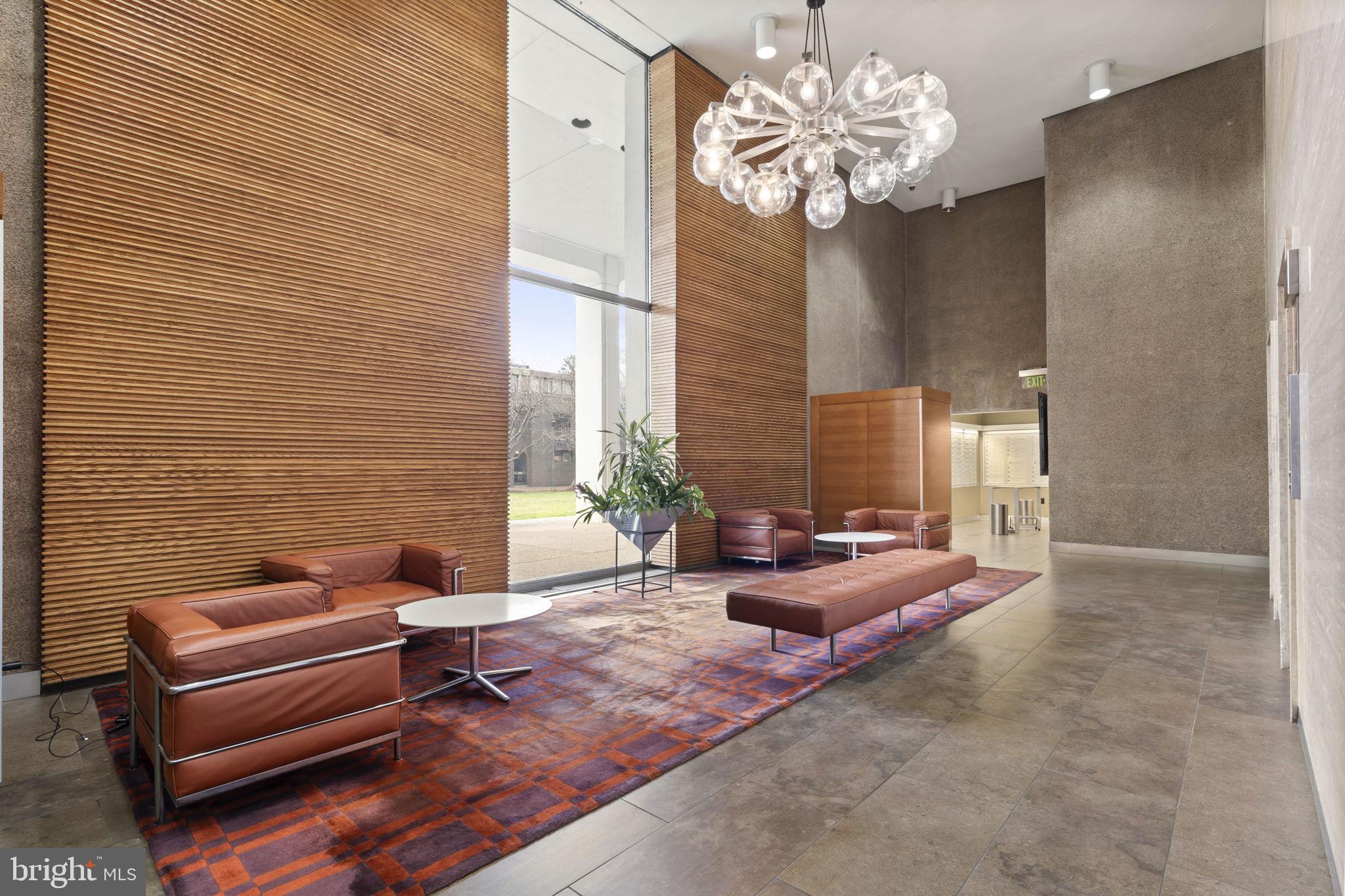 210 Locust Street, Unit 21E Philadelphia, PA 19106 - Photo 9 of 36 a living room with furniture and a chandelier