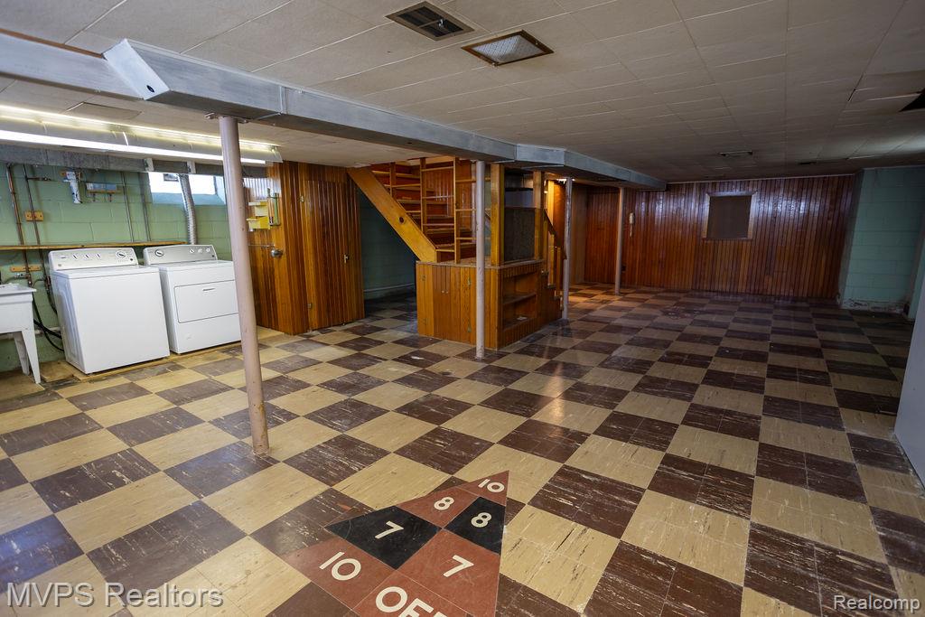 33033 Edgegrove Road Fraser, MI 48026 - Photo 17 of 20 Expansive lower level featuring checkerboard flooring, wood paneling, and an exposed ceiling