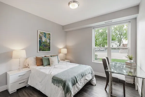 a bedroom with a bed and a large window