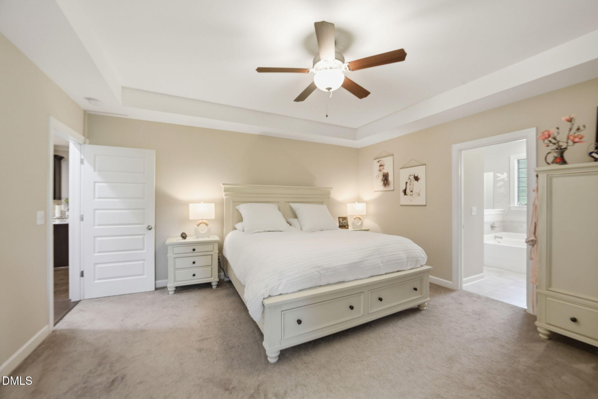 1547 Lassiter Pond Road Four Oaks, NC 27524 - Photo 18 of 45 a spacious bedroom with a bed and a chandelier