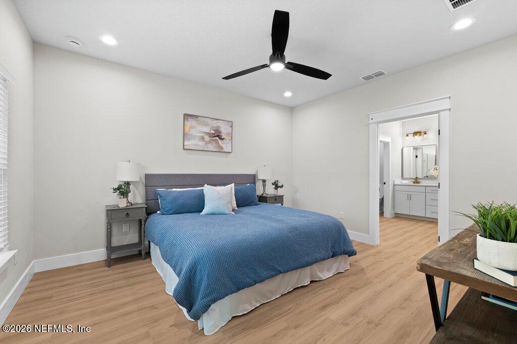 9019 Hipps Road Jacksonville, FL 32222 - Photo 30 of 35 a bedroom with a bed and a potted plant