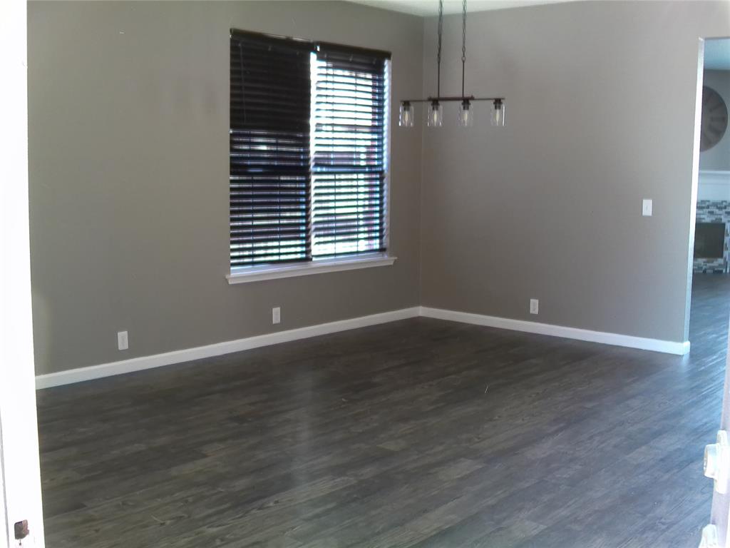 3240 Roddy Drive Fort Worth, TX 76123 - Photo 11 of 28 an empty room with wooden floor and windows