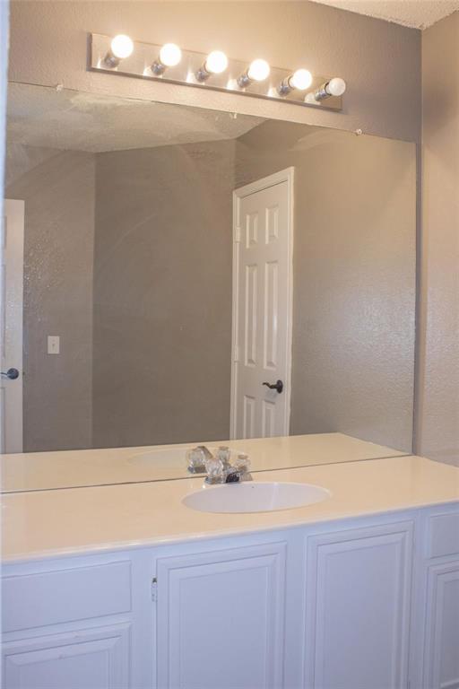 3240 Roddy Drive Fort Worth, TX 76123 - Photo 18 of 28 a bathroom with a sink and a mirror