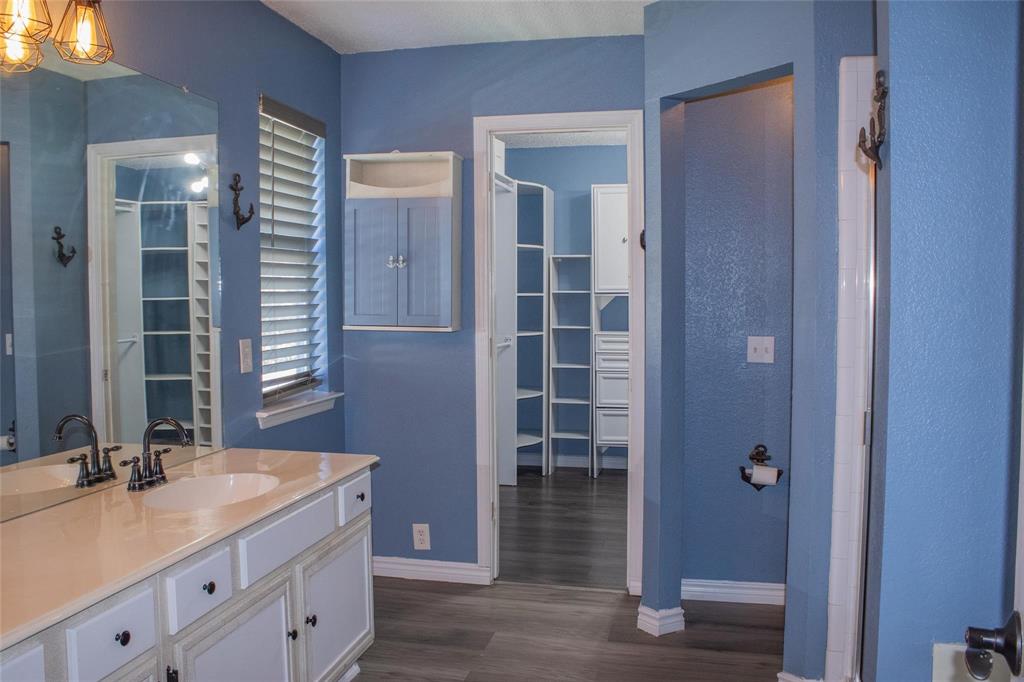 3240 Roddy Drive Fort Worth, TX 76123 - Photo 23 of 28 a bathroom with a granite countertop sink a mirror and a shower