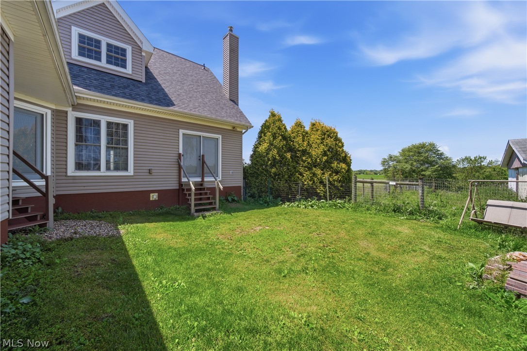 12159 Lawndell Road Southwest Beach City, OH 44608 - Photo 7 of 49 Expansive green lawn bordering the property, featuring a full fence line
