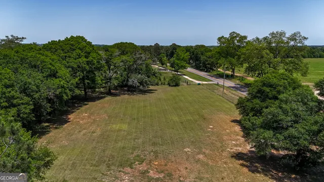 a view of a house with brick walls and a large tree