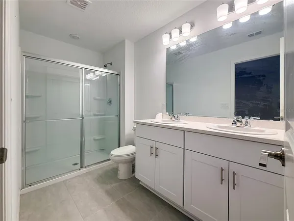 a bathroom with a toilet sink and shower