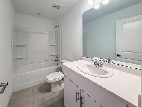 a bathroom with a sink a toilet and bathtub