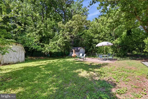a swimming pool with outdoor seating and yard