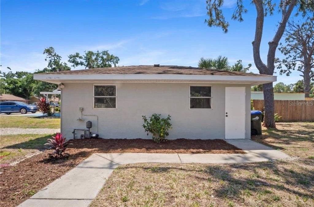 2981 Crane Avenue North Port, FL 34286 - Photo 14 of 16 a front view of a house with a yard