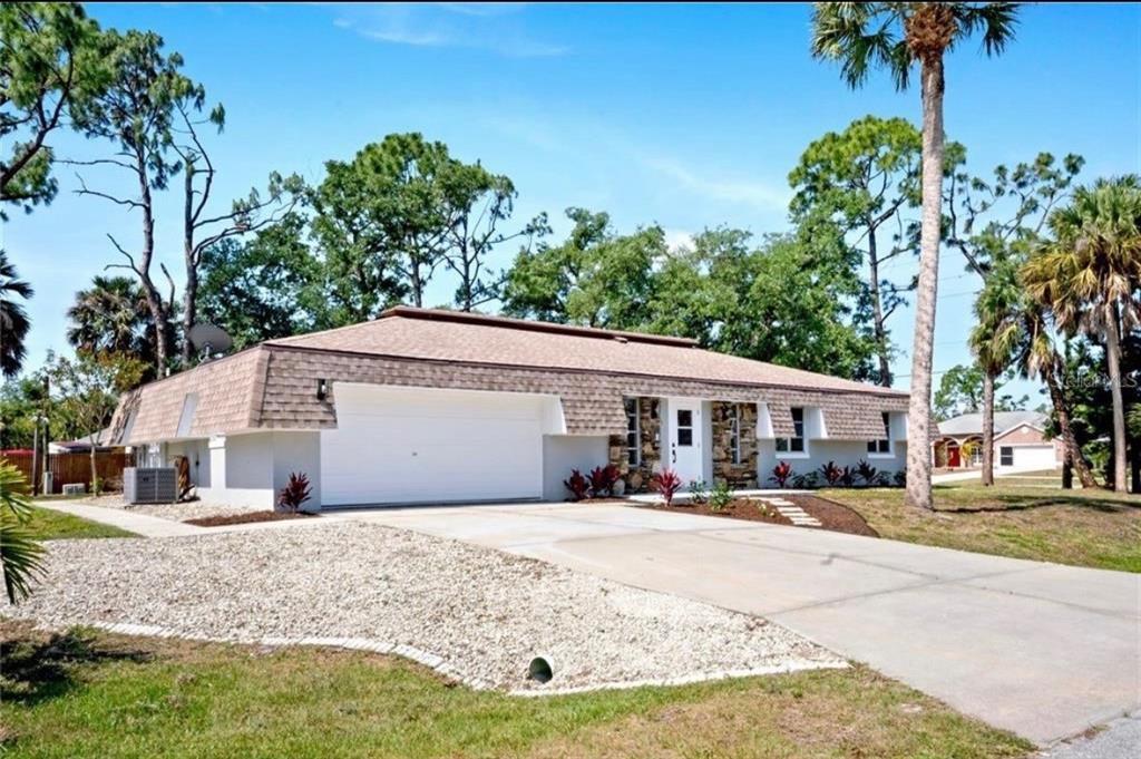 2981 Crane Avenue North Port, FL 34286 - Photo 2 of 16 a front view of a house with a yard and potted plants