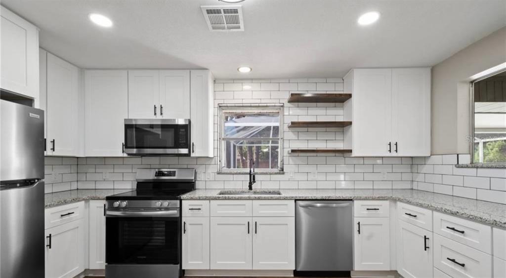 2981 Crane Avenue North Port, FL 34286 - Photo 3 of 16 a kitchen with appliances a sink and cabinets
