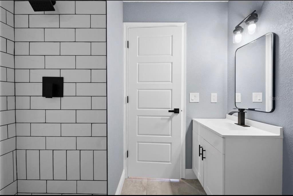 2981 Crane Avenue North Port, FL 34286 - Photo 6 of 16 a bathroom with a sink and a mirror