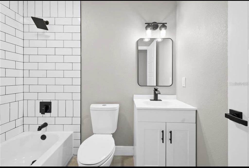 2981 Crane Avenue North Port, FL 34286 - Photo 9 of 16 a bathroom with a toilet sink and mirror