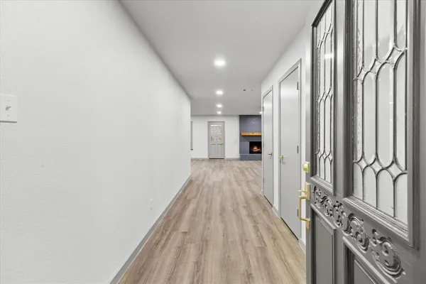 a view of a hallway with wooden floor