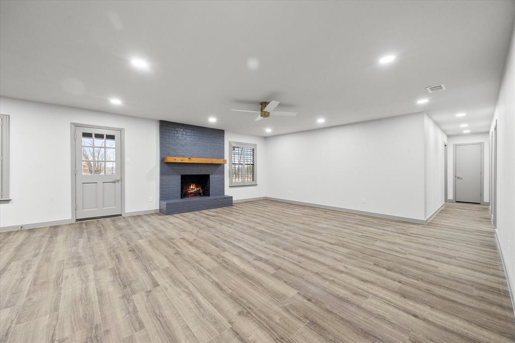 8 Harker Circle Rockwall, TX 75087 - Photo 5 of 29 a view of an empty room with wooden floor and fireplace