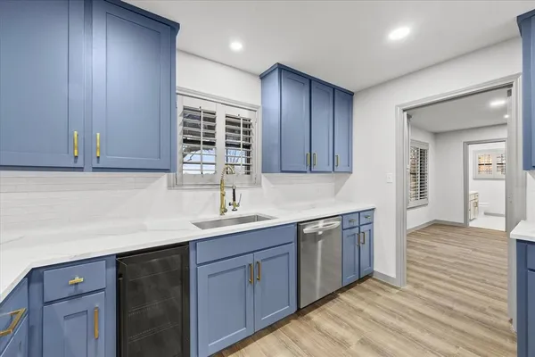 a kitchen with a sink cabinets and wooden floor