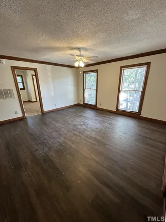 a view of an empty room with windows