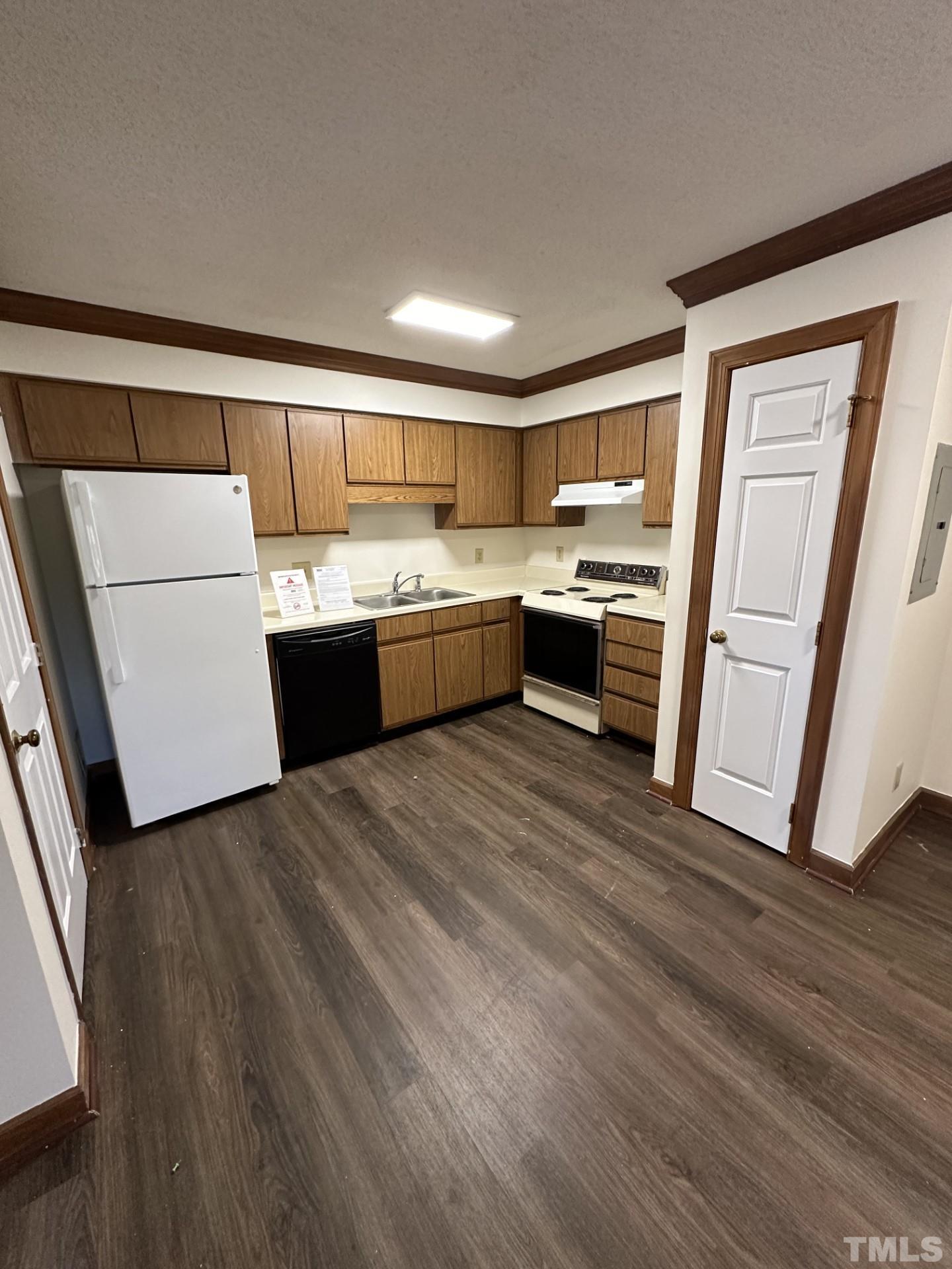 3531 Ivy Commons Drive, Unit 302 Raleigh, NC 27606 - Photo 3 of 4 a large kitchen with a wooden floor and a sink