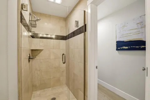 a bedroom with a bed and a mirror