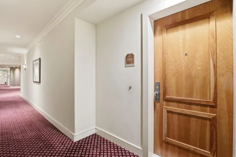 a view of walk in closet with wooden floor