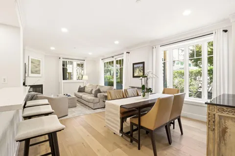 a living room with furniture and large windows