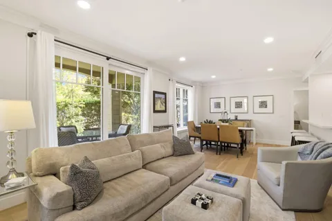 a living room with furniture and large windows