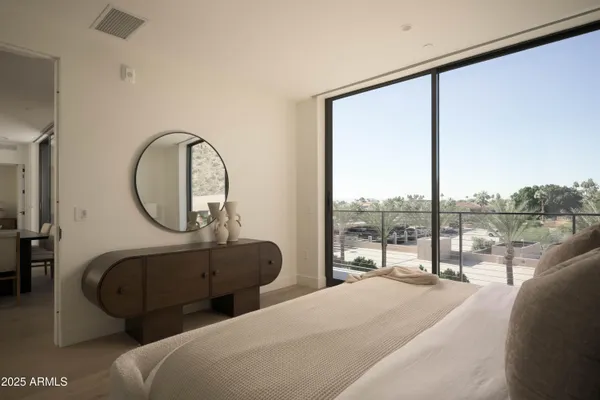 a bedroom with a large bed and a large window