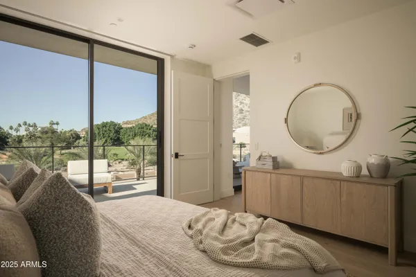 a bedroom with a large bed and a large window